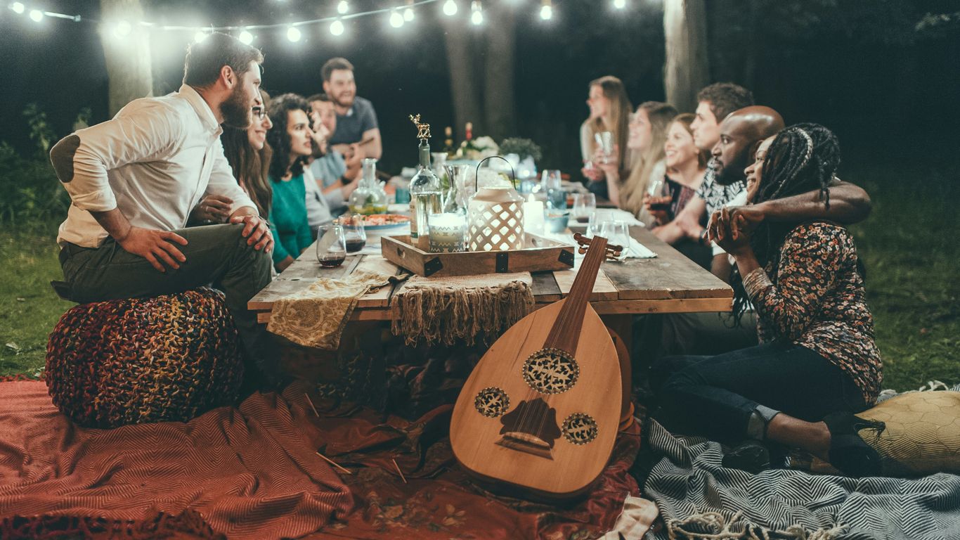 people sitting on chair in front of table with candles and candles