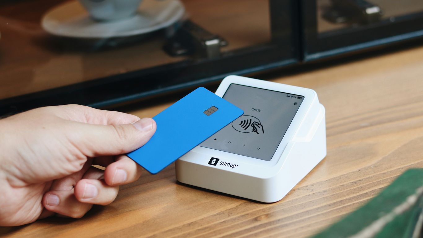 A person holding a blue card in their hand