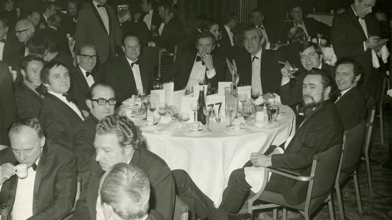 a large group of people sitting around a table