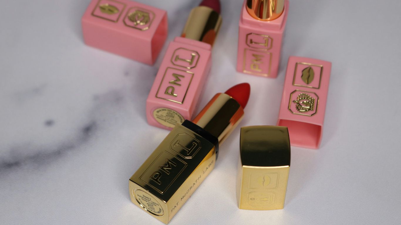 pink and brown lipstick on white table