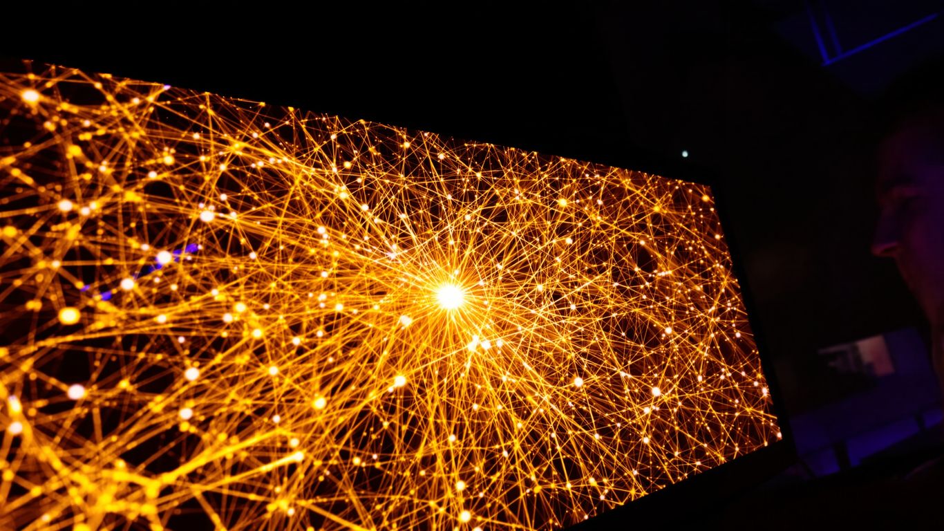 Computer displaying glowing neural network visualization.