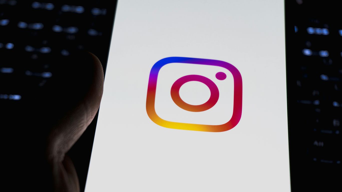 Instagram's logo is displayed on a phone.