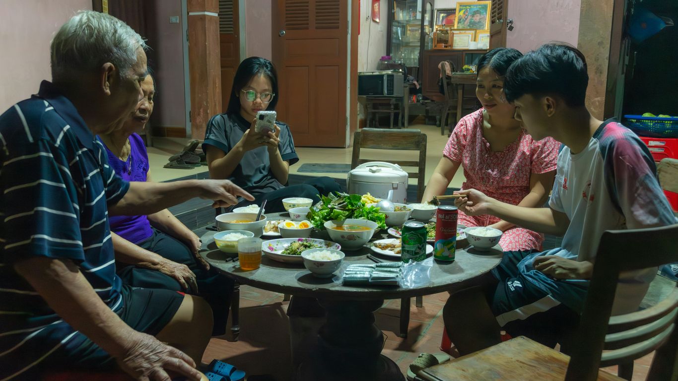 a group of people sitting around a table eating food