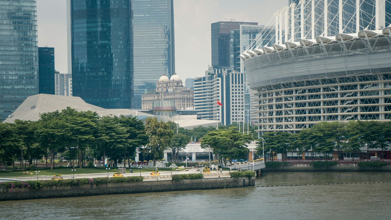 a body of water with a city in the background