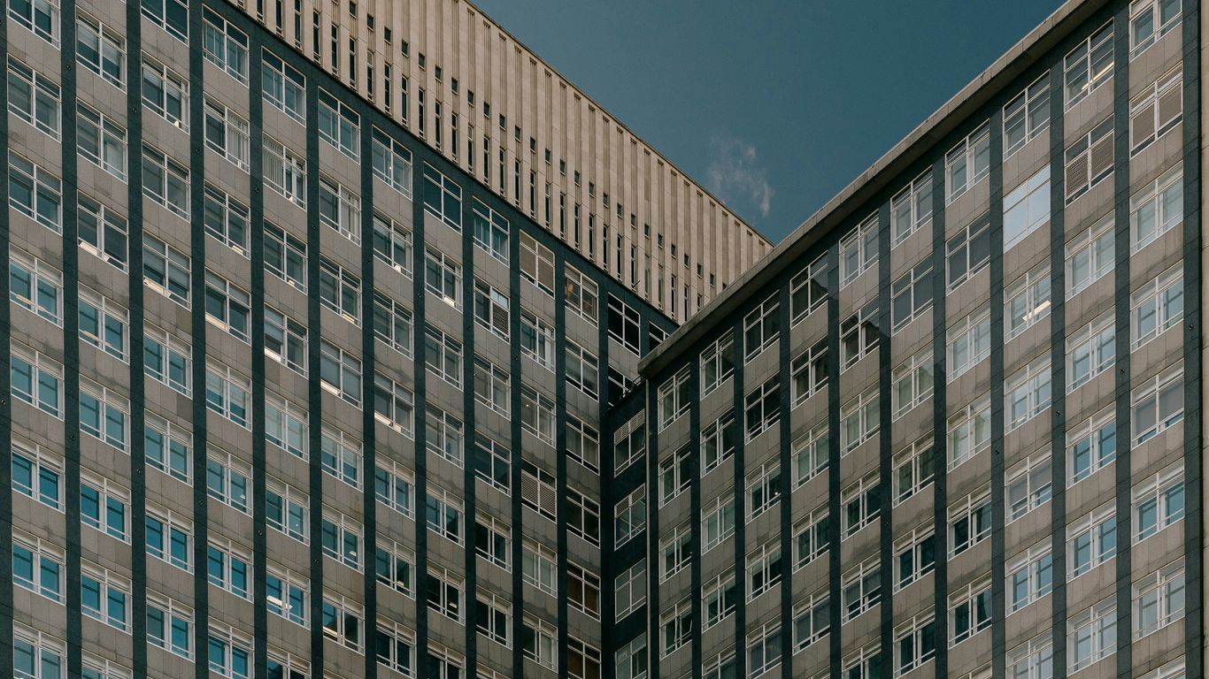 A couple of tall buildings sitting next to each other
