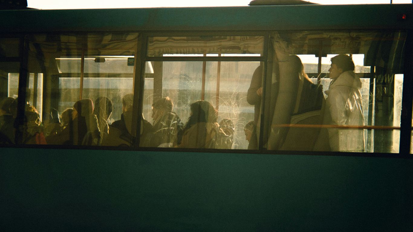 People are riding inside a bus during daylight.