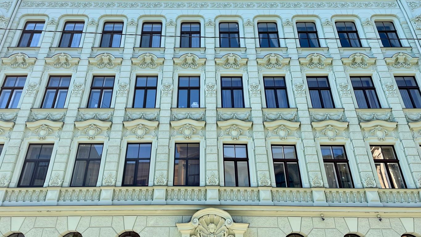 a large white building with many windows and a clock
