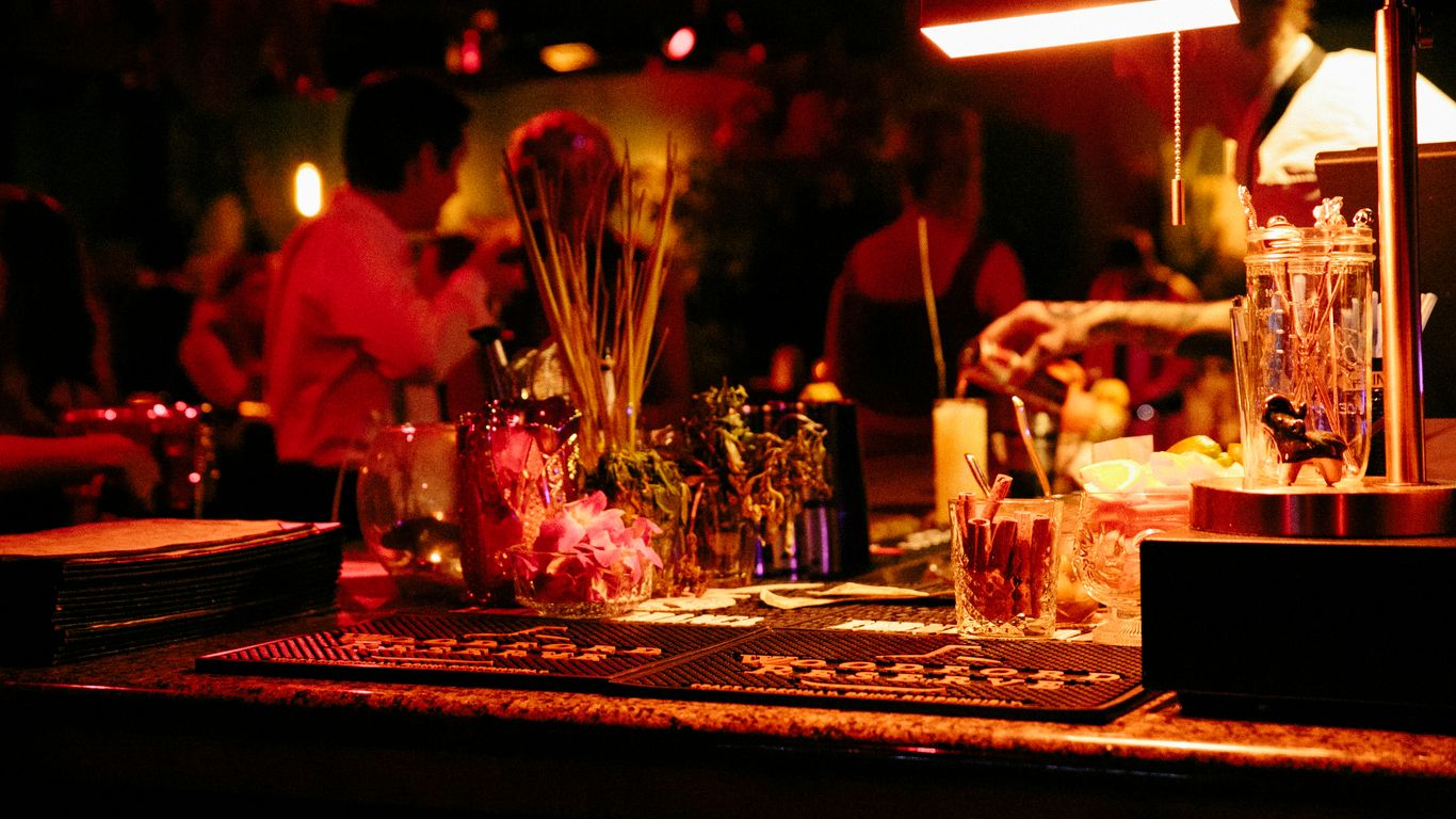a bar with a bunch of bottles and glasses on it