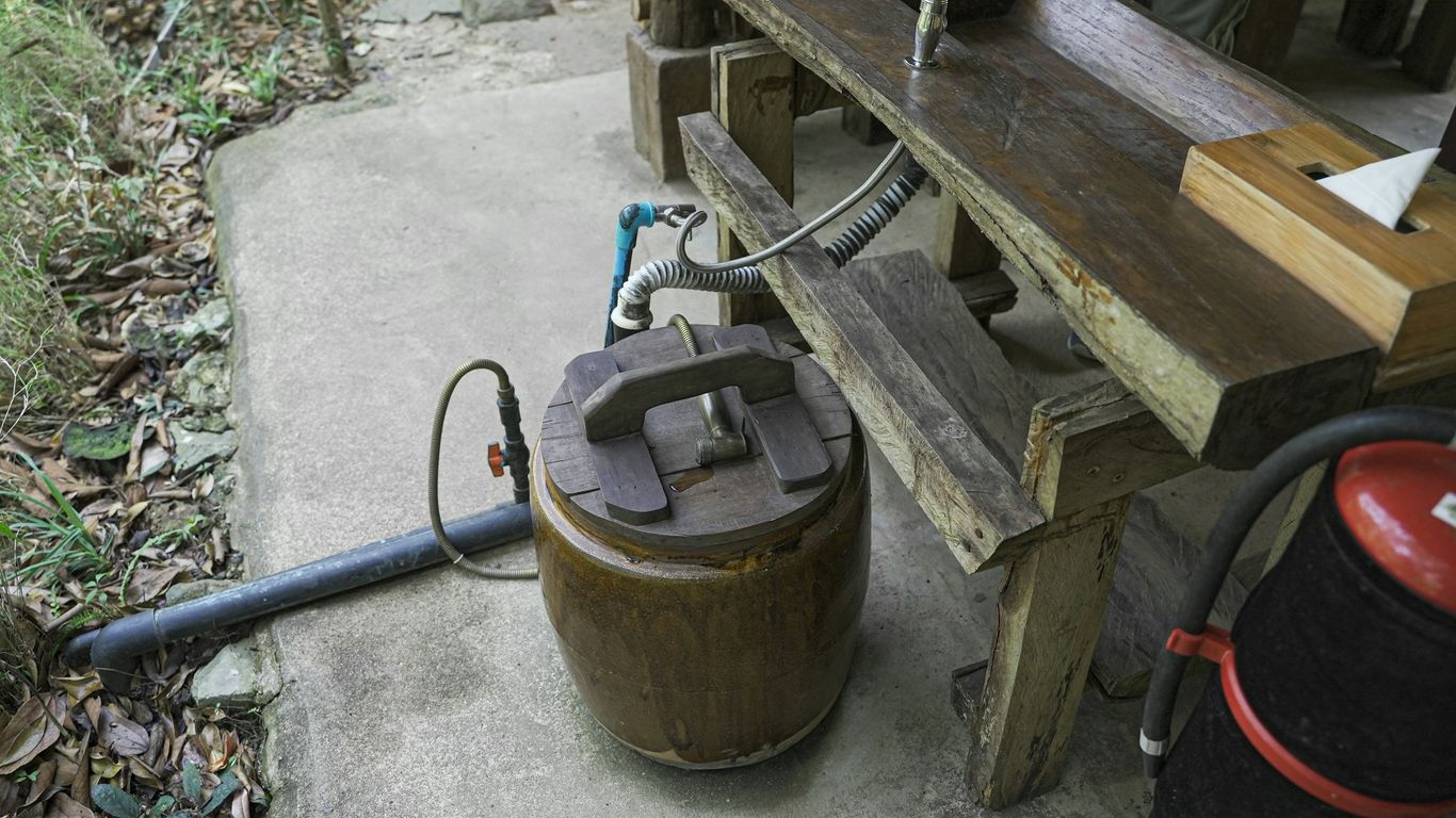 a wooden bench with a hose connected to it