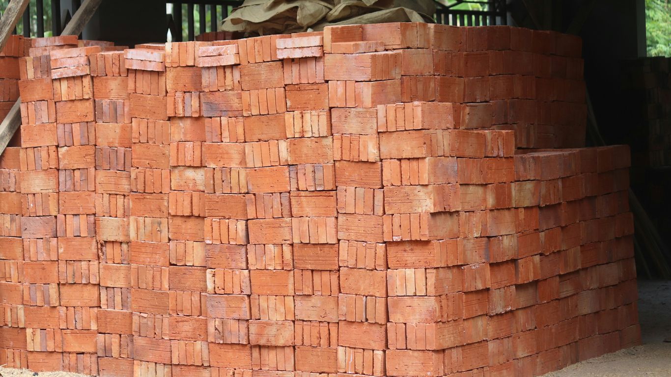 a pile of bricks sitting on top of a sidewalk