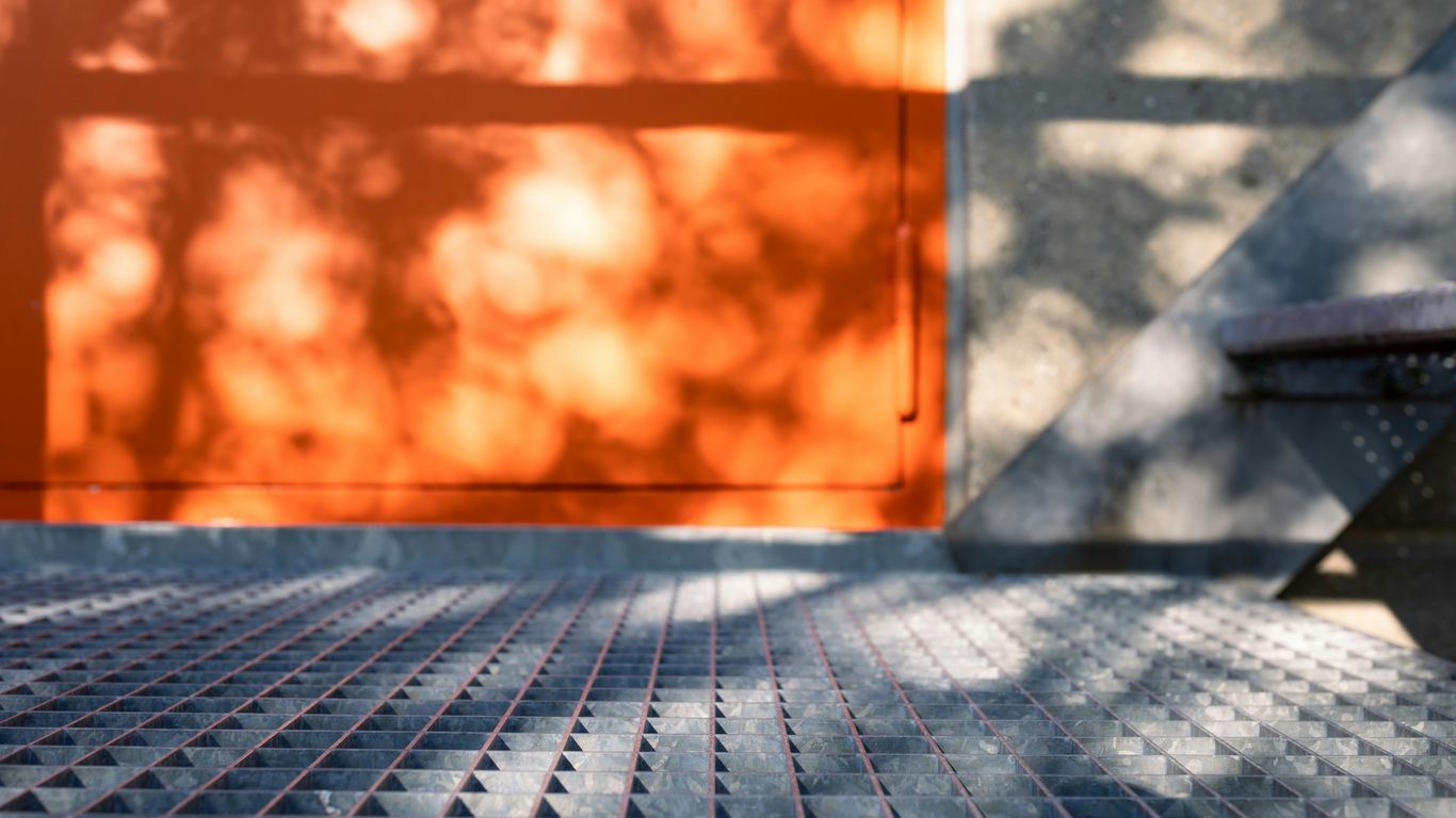 brown wooden door on gray concrete brick wall