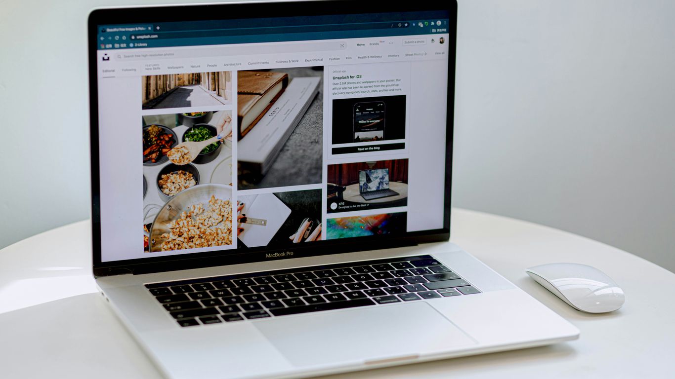 macbook pro on white table