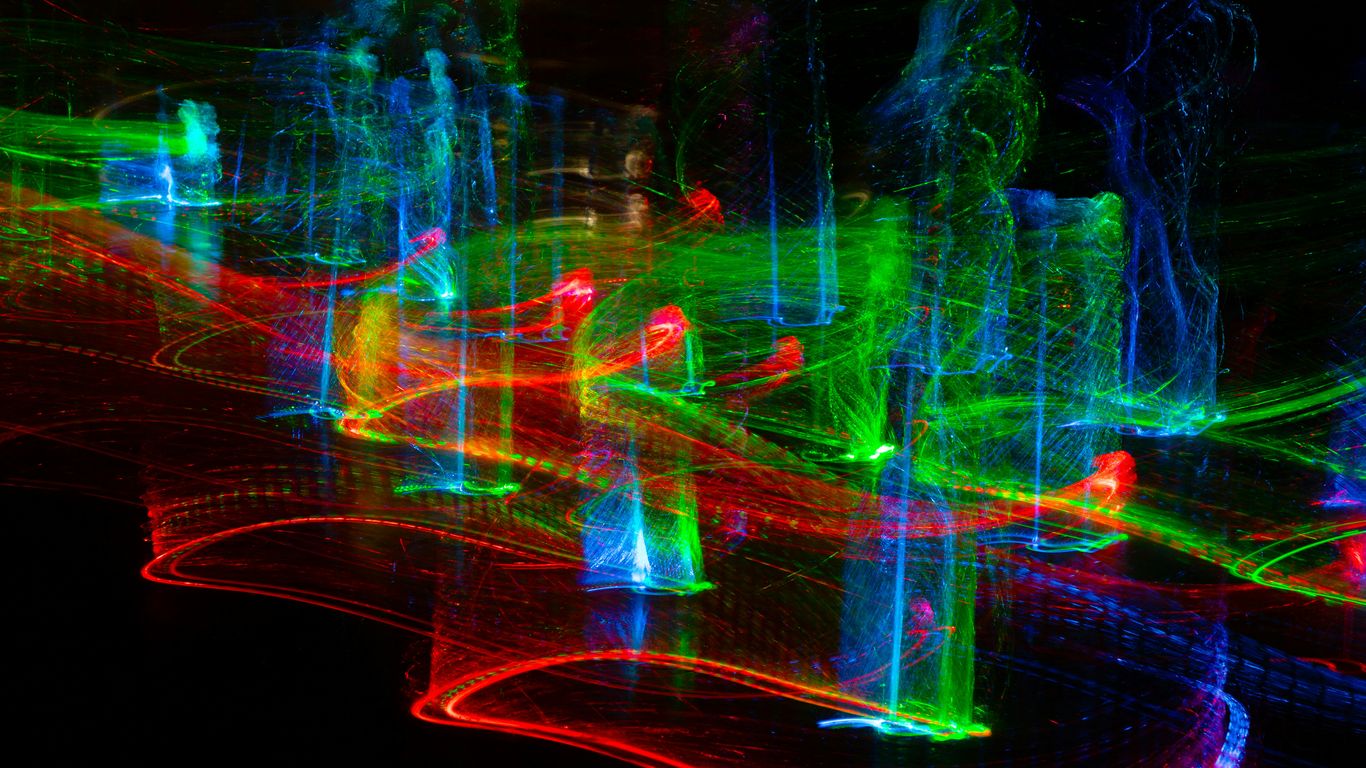 Abstract streaks of colorful lights on black background