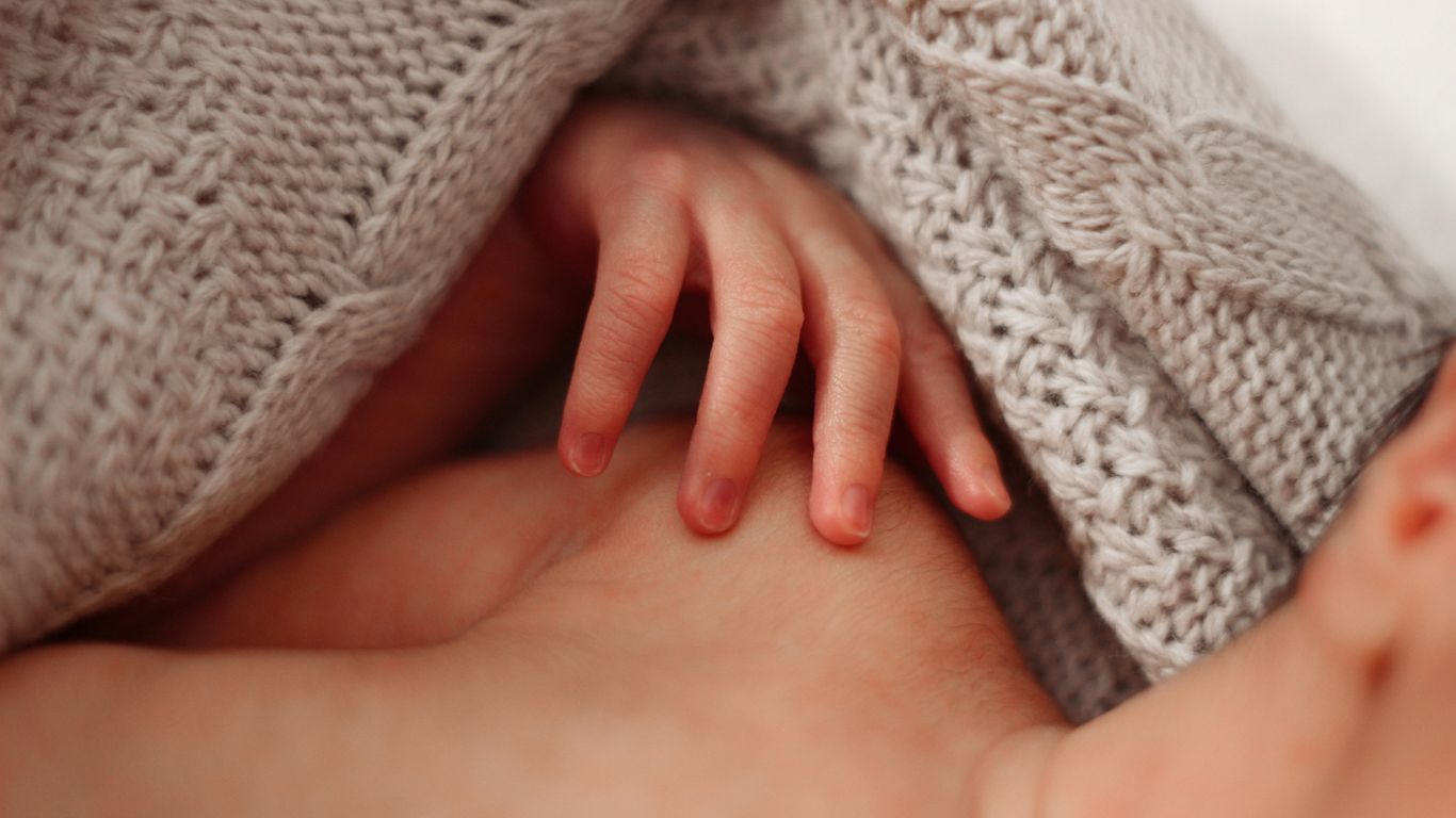 a close up of a baby wrapped in a blanket