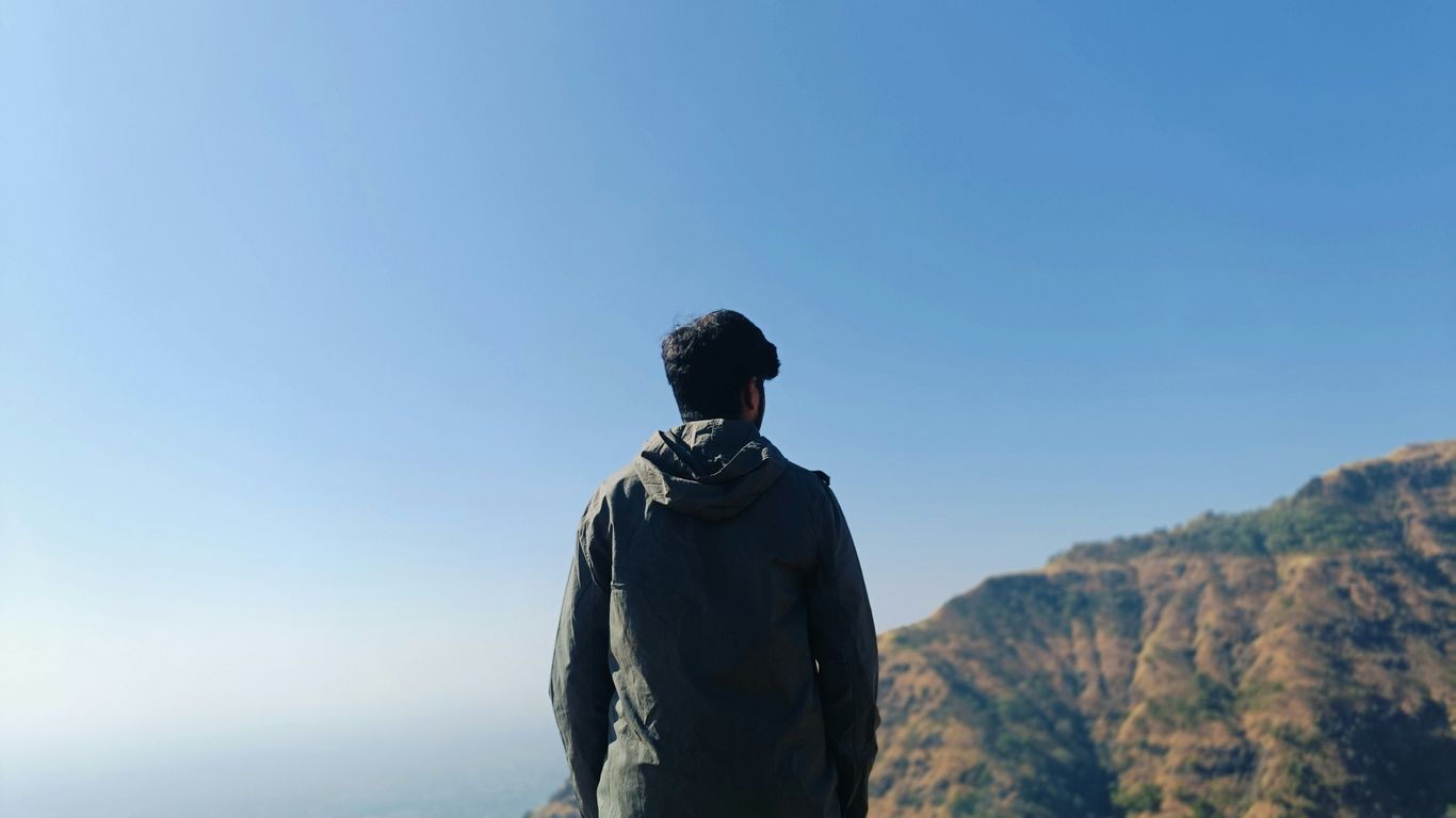 Man looking at a mountain landscape