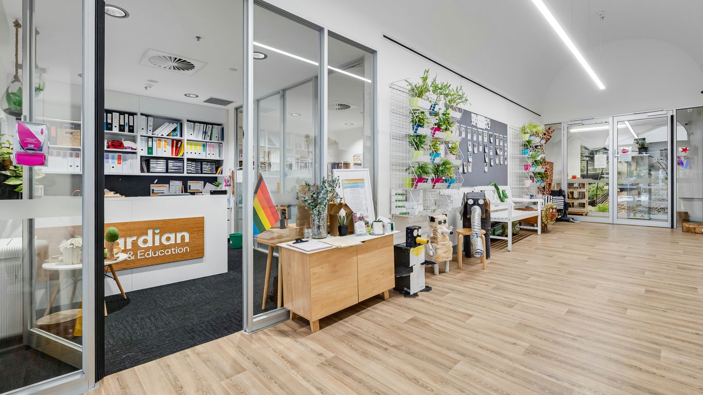 A store with a wooden floor and white walls