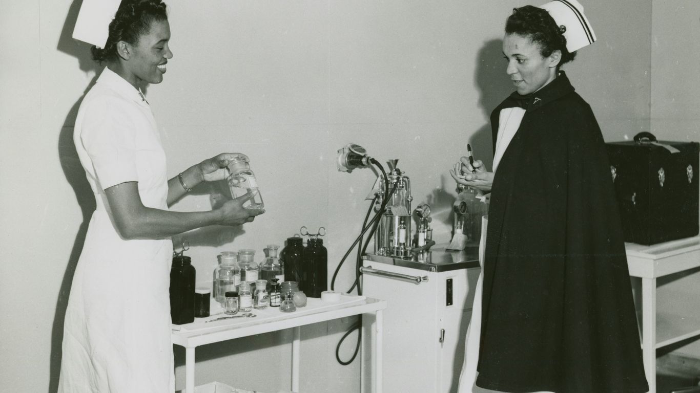 two female nurses talking in a hospital room
