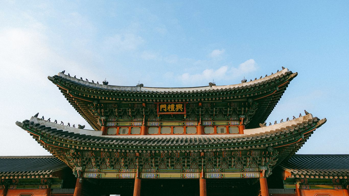 A tall building with a sky in the background