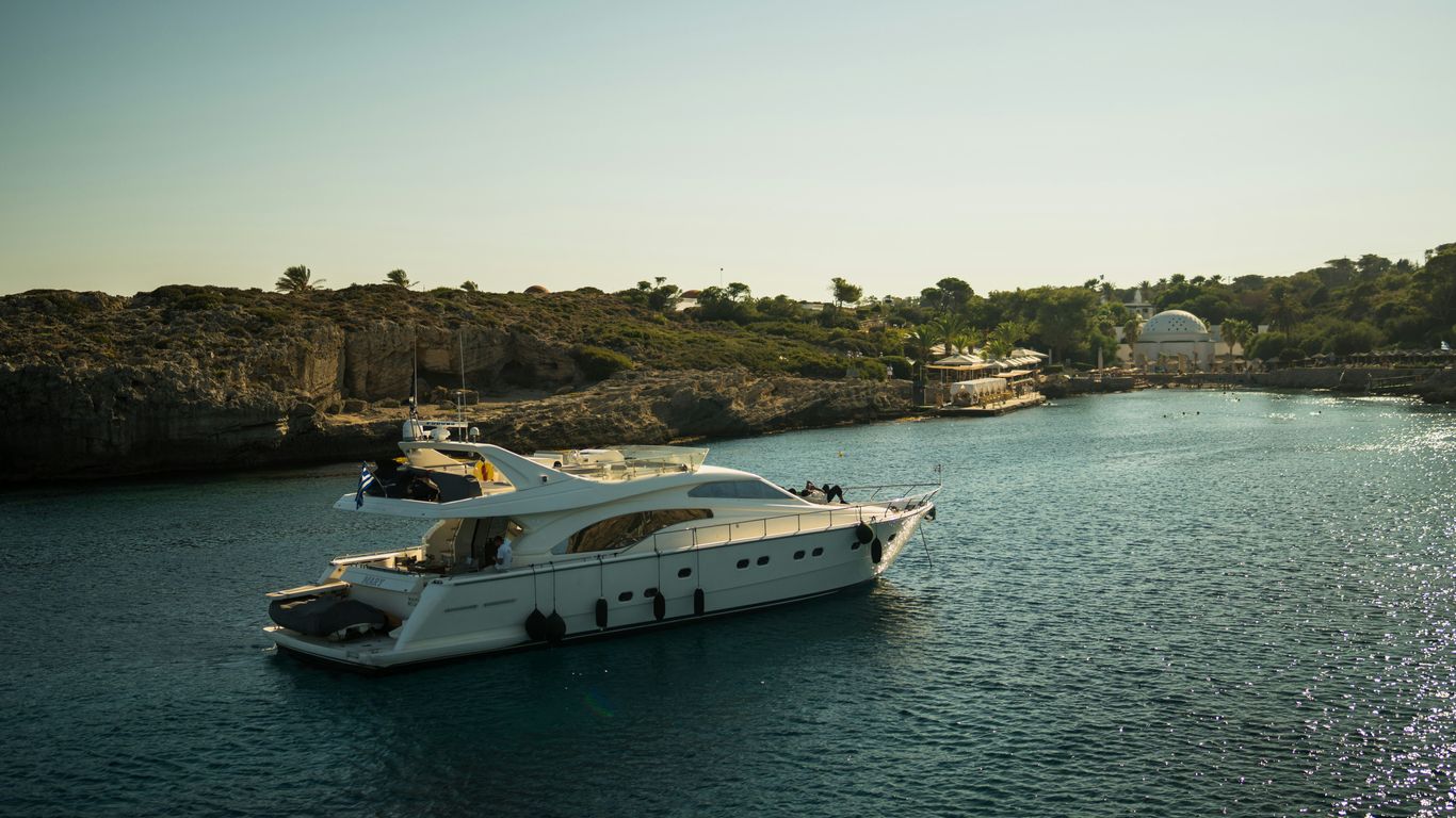 A large white boat floating on top of a body of water