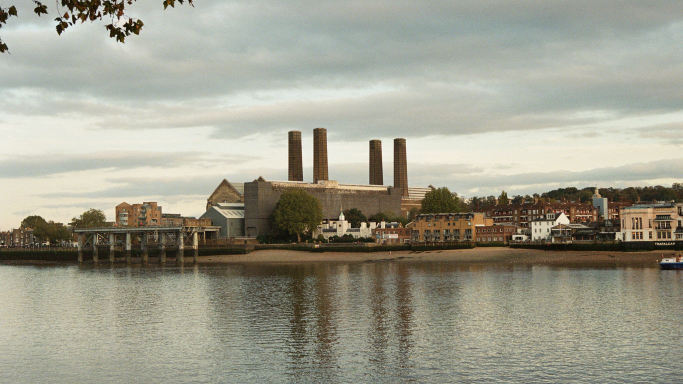 Industrial buildings with smokestacks by a river