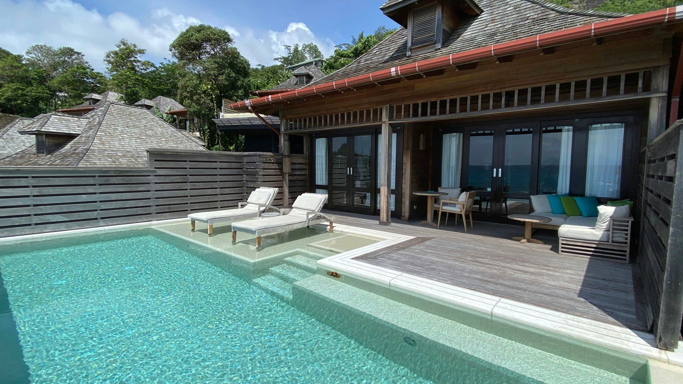 a house with a swimming pool in front of it