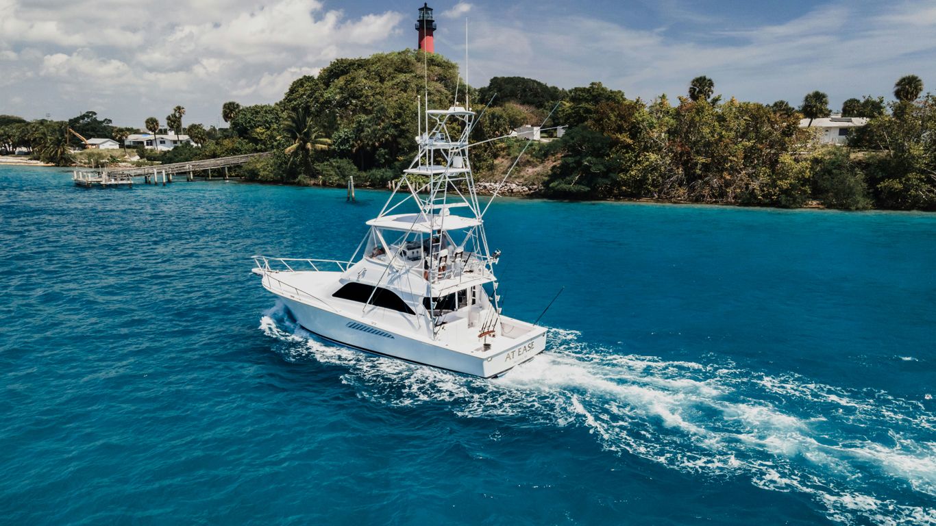 white and blue yacht on sea during daytime