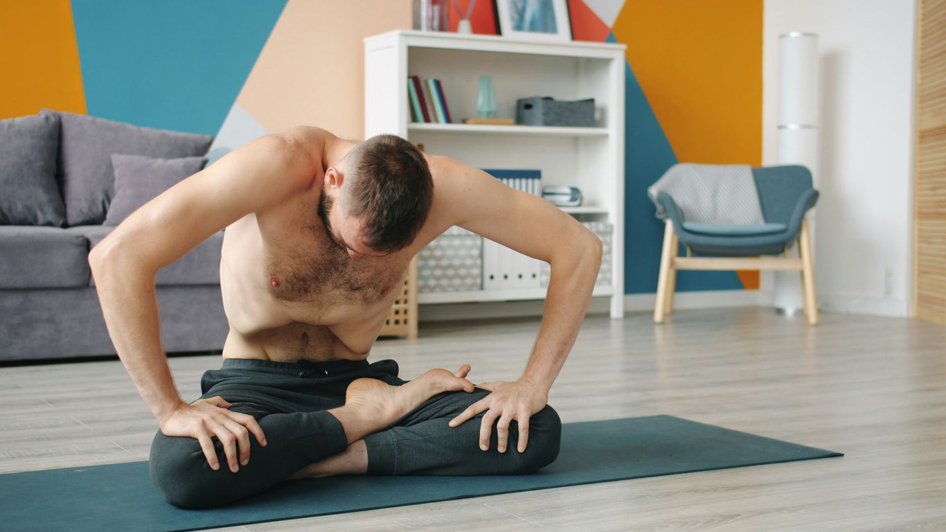 Man practicing yoga in a living room