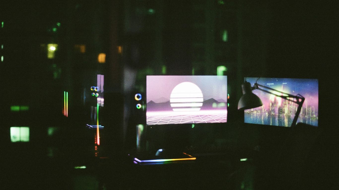 black flat screen tv turned on in a dark room
