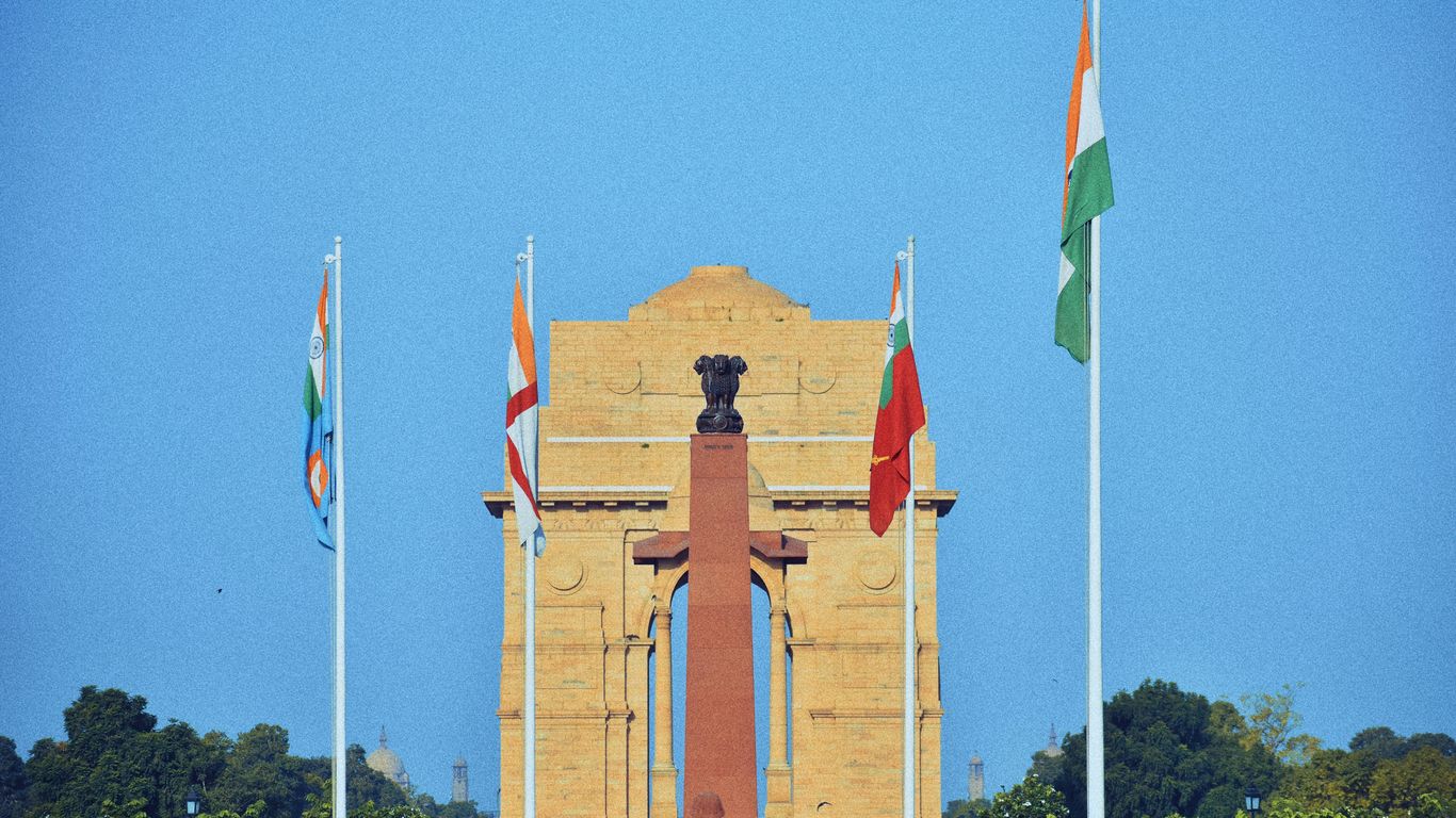 a clock tower with flags flying in front of it