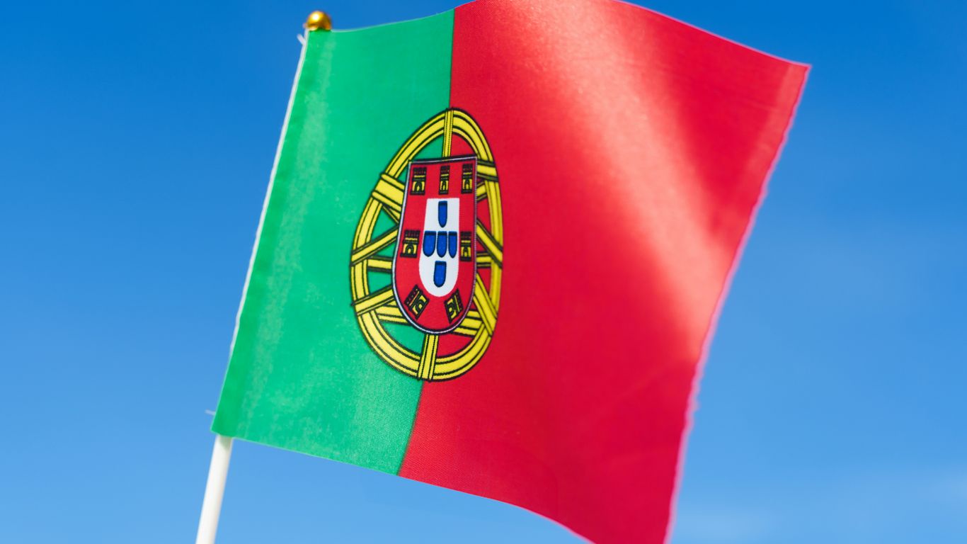 the flag of portugal is waving in the wind