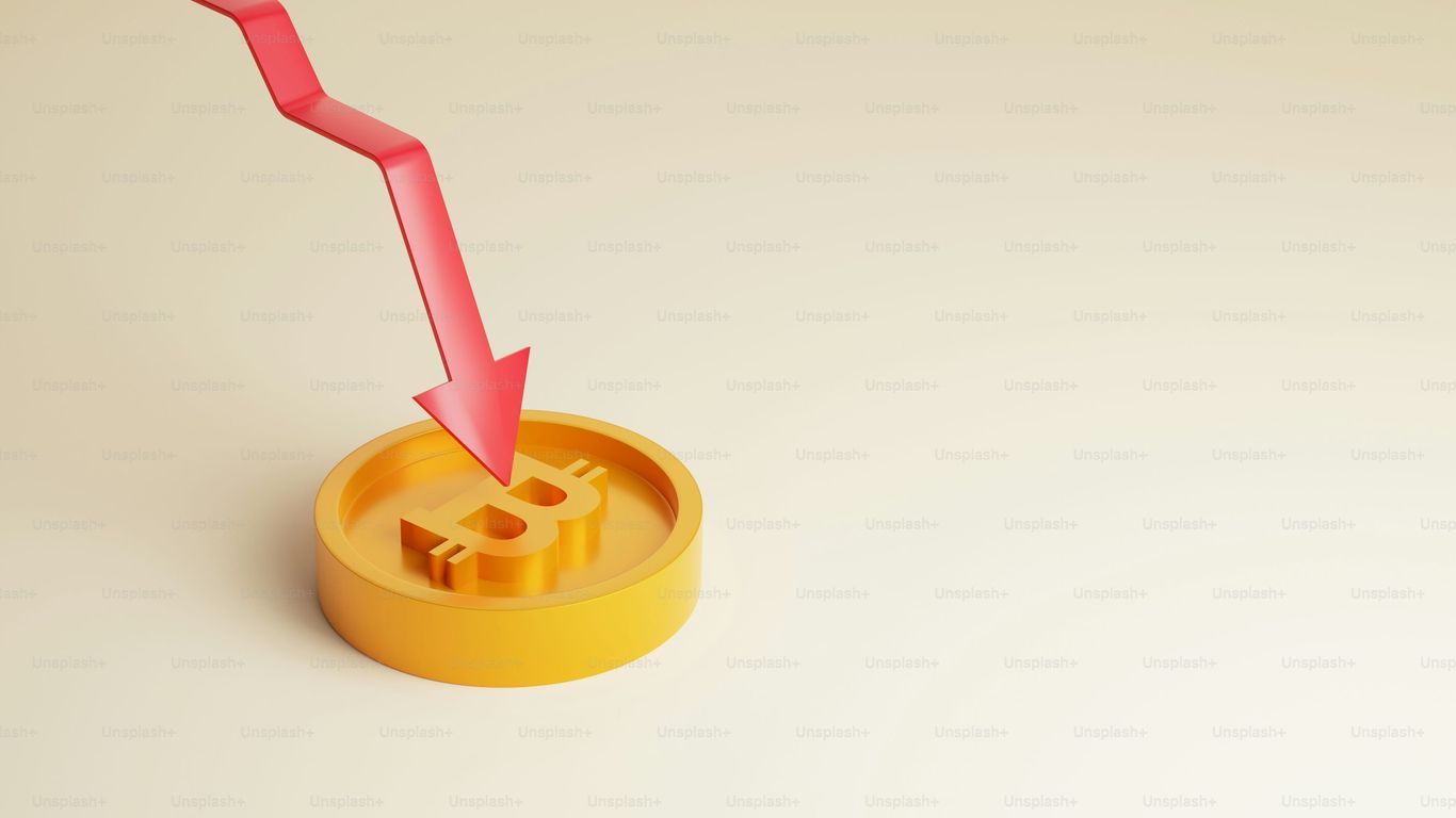 A Bitcoin symbol with a downward red arrow indicating decline.