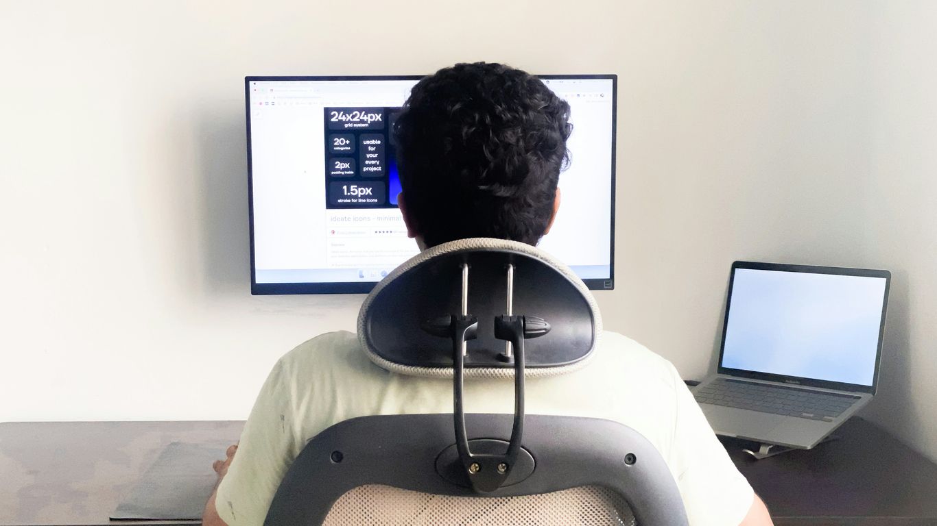 a man sitting in front of a computer monitor