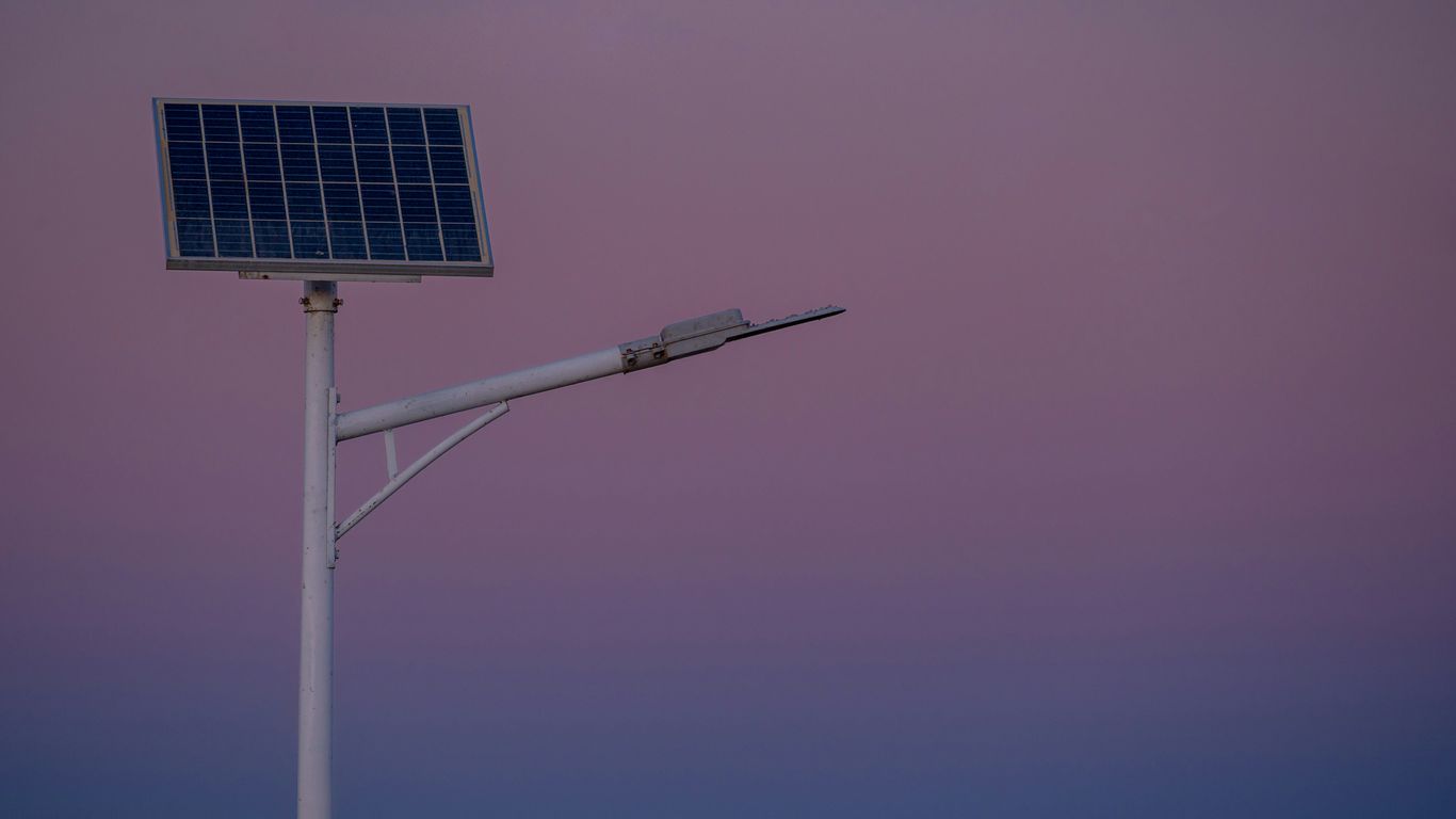 Solar panel street lamp against a twilight sky