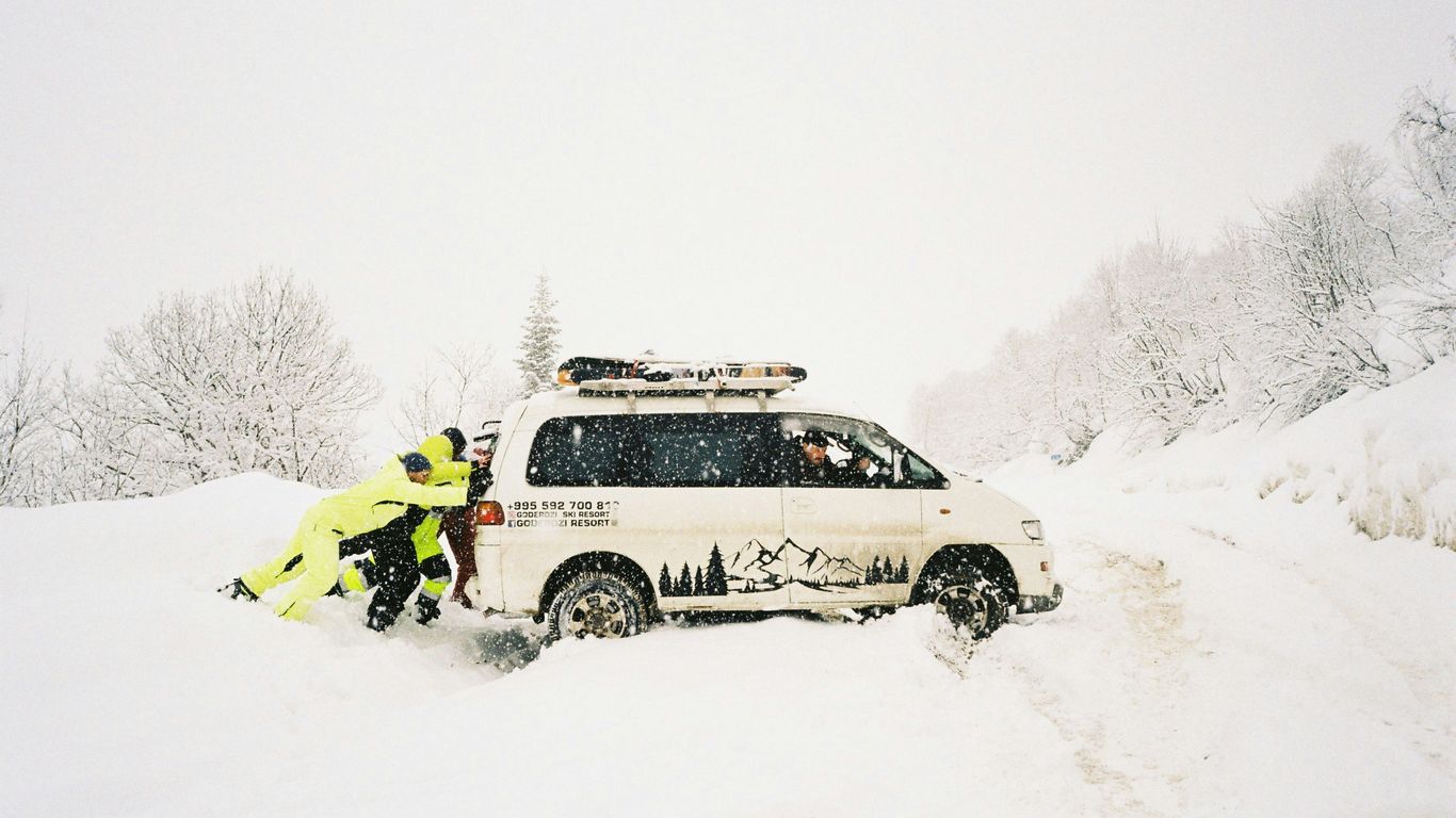 A couple of people that are standing in the snow