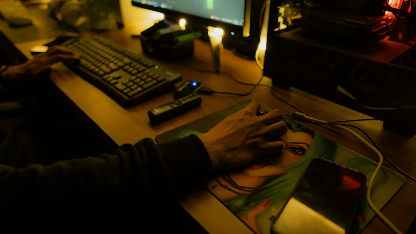 Person using a computer at a desk.