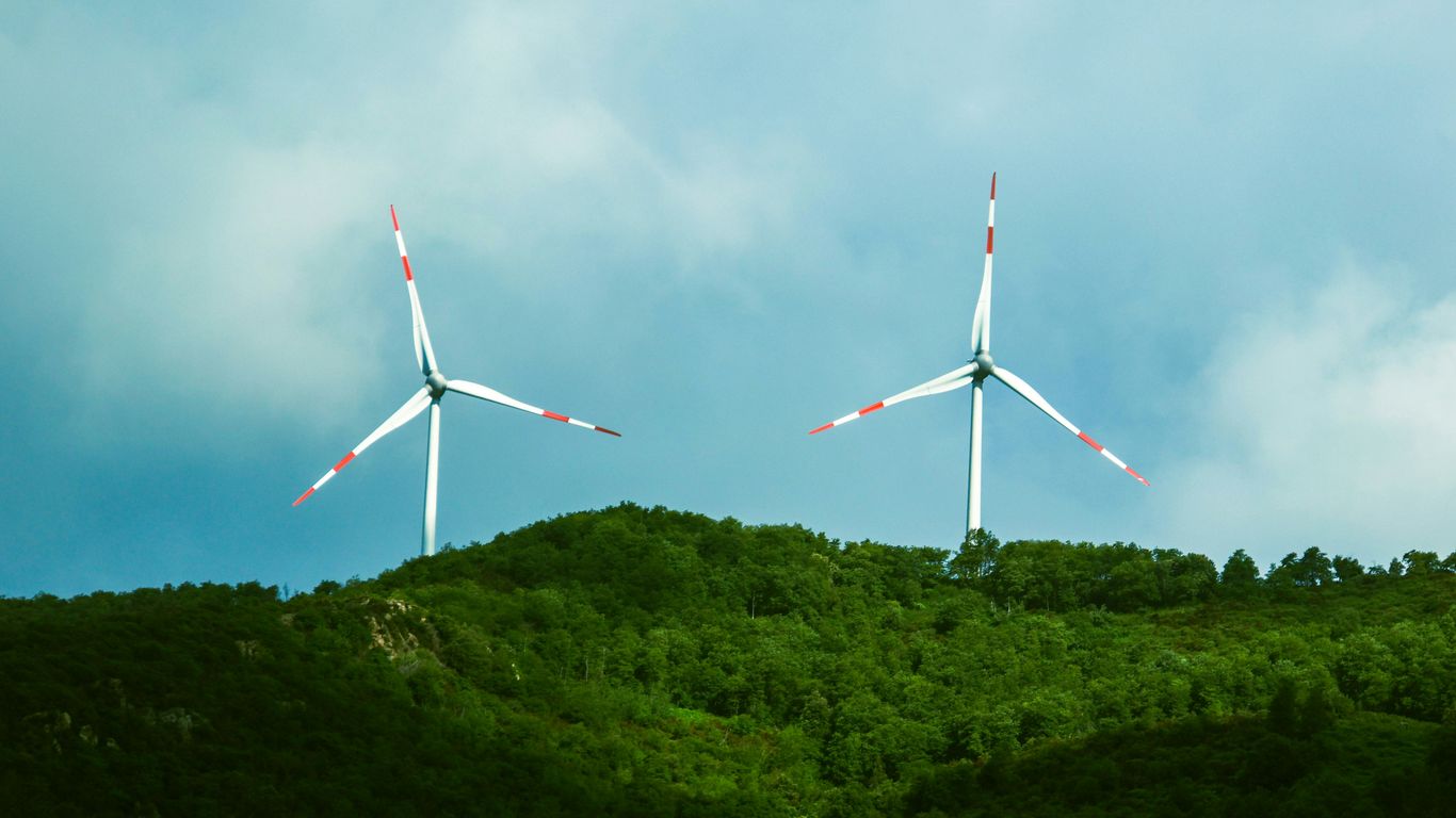 a couple of windmills that are on a hill
