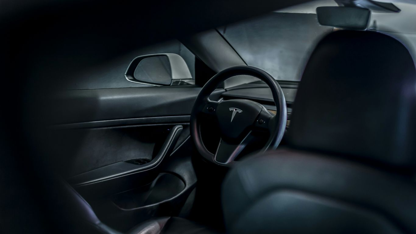 the interior of a car with a steering wheel and dashboard