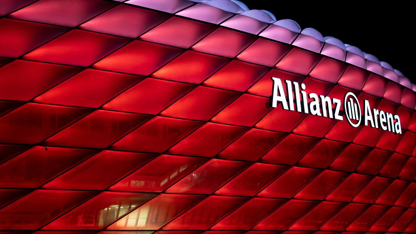a large red building with a sign that says allianz arena