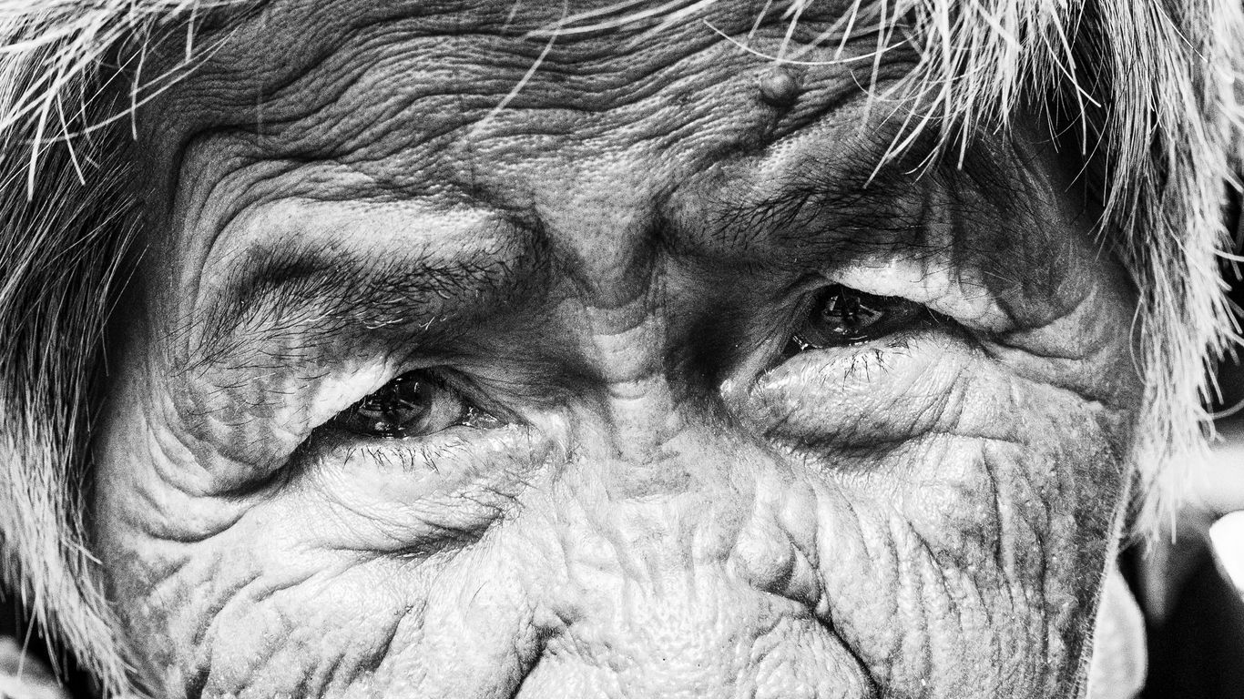 A black and white photo of an old woman