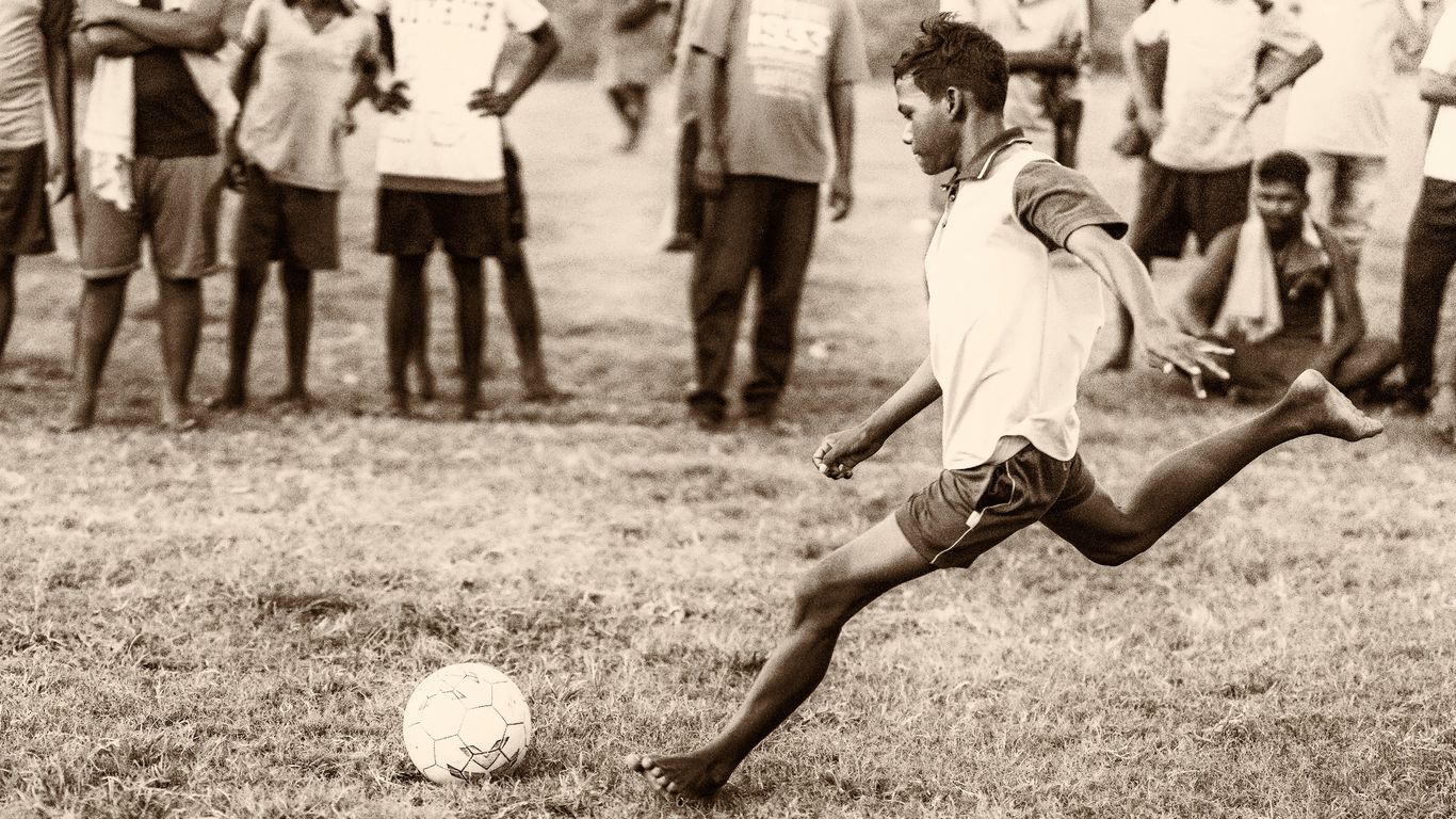 grayscale photo of 2 men playing soccer
