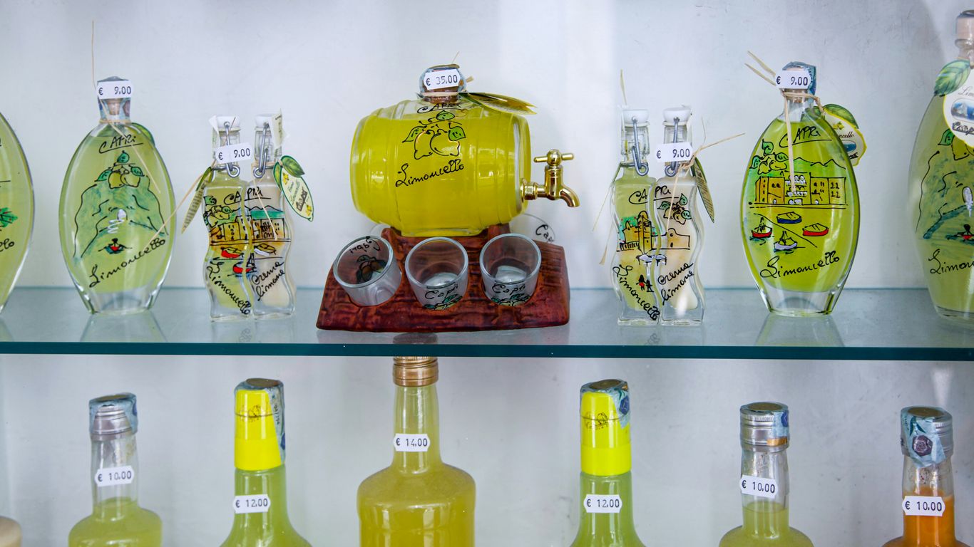 assorted bottles on glass shelf