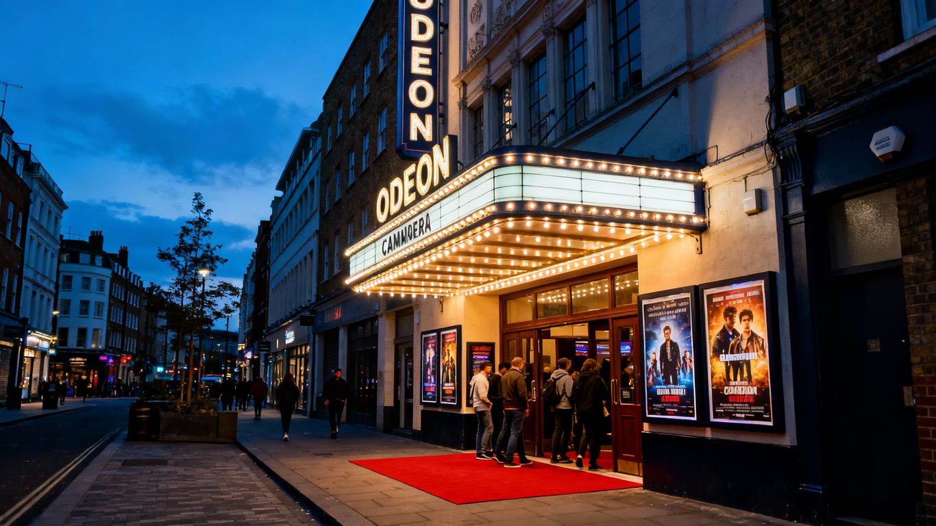 Odeon Camden Cinema exterior at night with moviegoers