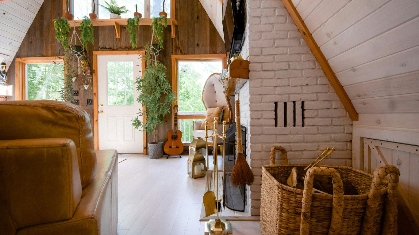brown wooden acoustic guitar near brown wicker armchair