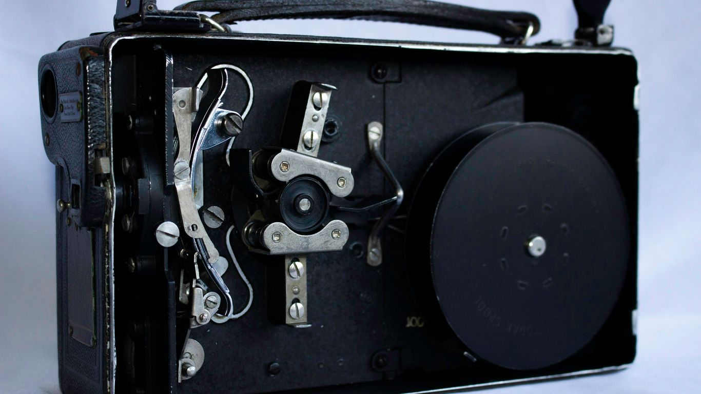 An old black camera with a white background