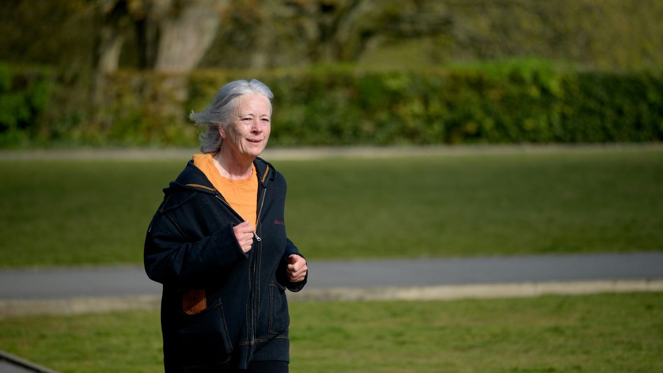 An older woman jogging in the park