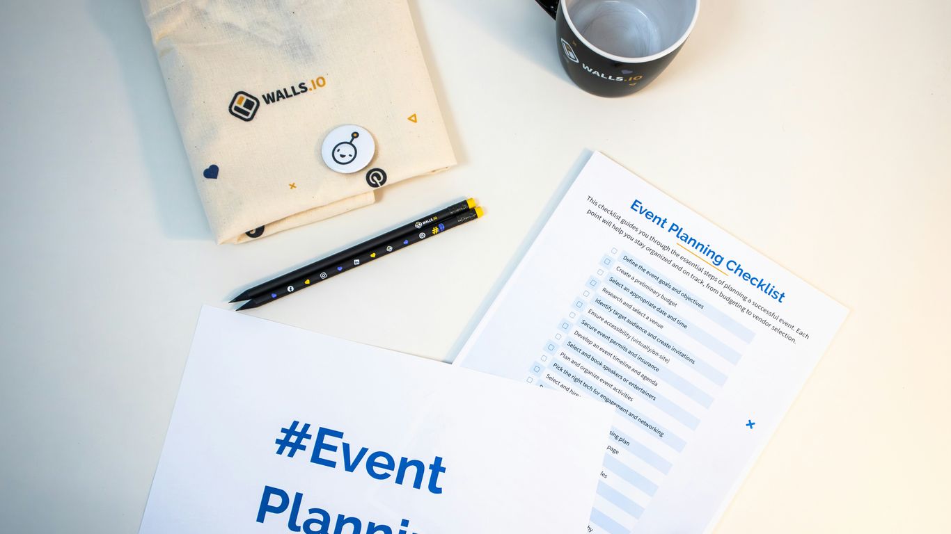 a table with a coffee cup, notepad, pen, and envelope