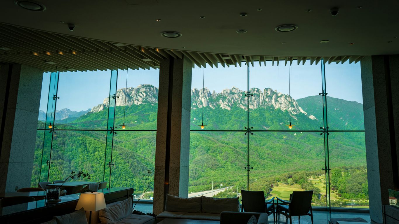 a living room filled with furniture and a large window