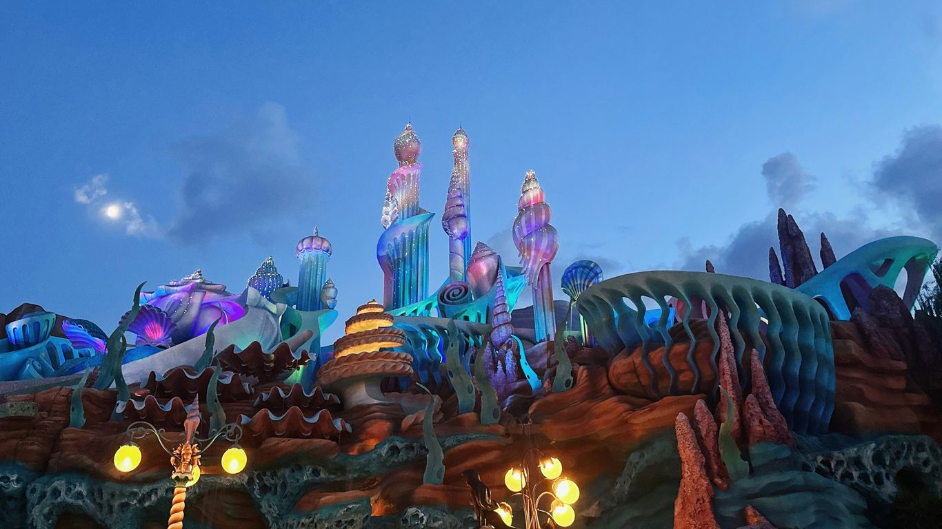 a futuristic city is lit up at night