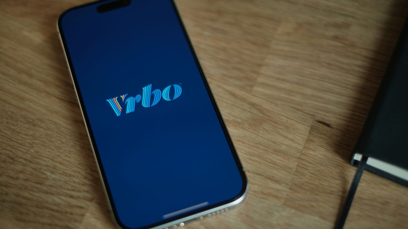 A cell phone sitting on top of a wooden table