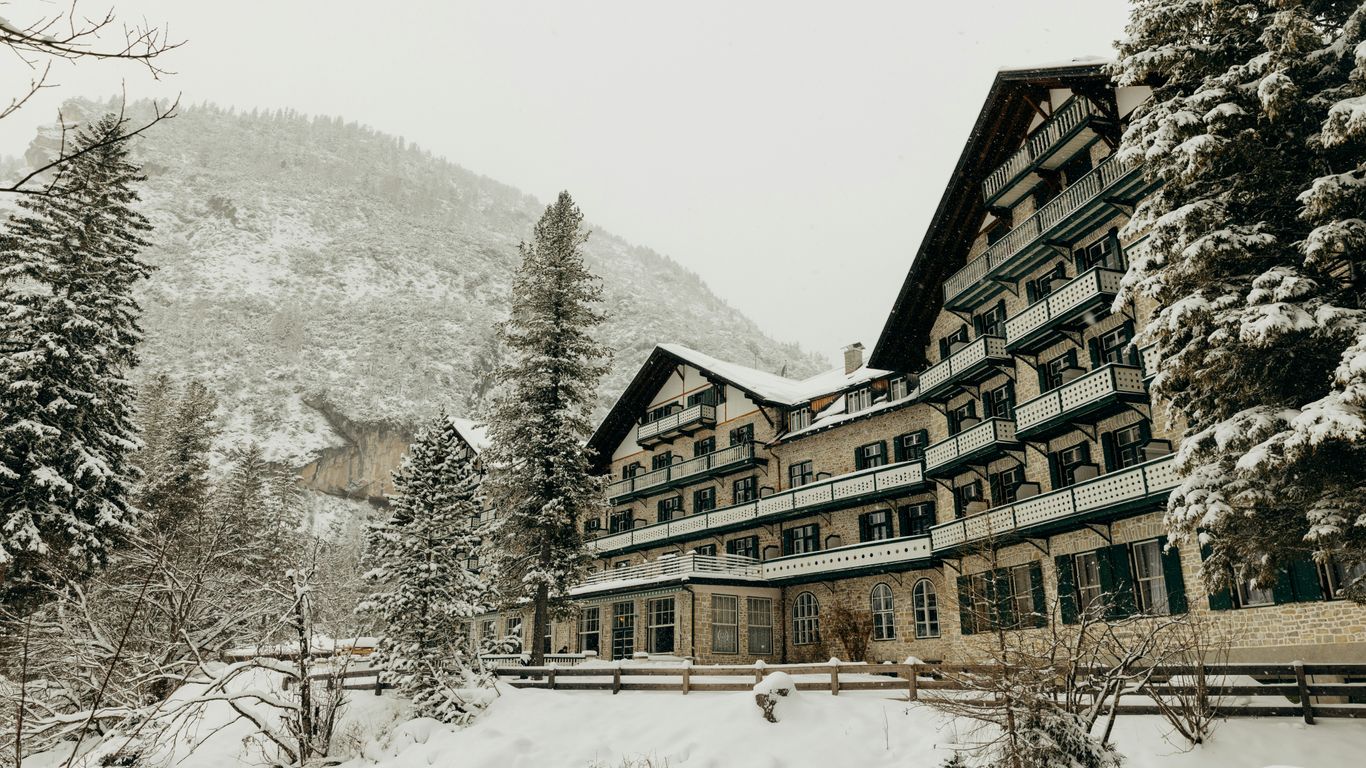 A large building surrounded by snow covered trees